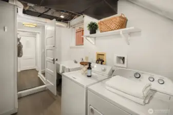 Downstairs offers high ceilings, ALOT of storage and a nice laundry area with utility sink- door leads to the MIL/ Apartment