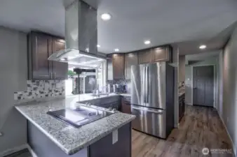 Kitchen and hall that leads to the garage straight ahead. Utility area is on the left before you open the door to the garage