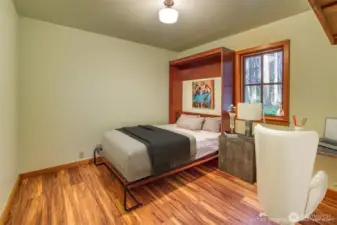 Murphy bed in one of two main floor bedrooms allows for flexible use of space.