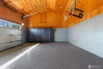 The ultimate garage setup featuring a 10’ basketball hoop, custom Garage Living organization system, and EV charger