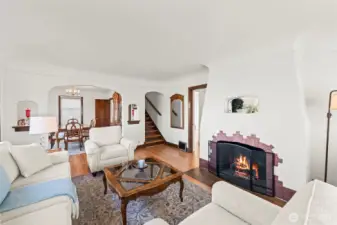 Fireplace Detail: The heart of the home features a stunning gas fireplace with unique tilework and a coved ceiling, perfect for cozy evenings. Architecturally unique niches and mirrors add a touch of vintage flair.