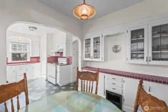 Leaded Glass Built-ins: The breakfast area includes beautiful built-in cabinetry with leaded glass doors, offering both elegant display space and practical storage that stays true to the home's period roots.
