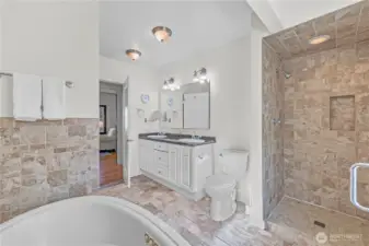 Luxury 5-Piece Bath: The spacious main-floor bathroom is a true sanctuary, complete with a jetted soaking tub, a tiled shower, and a dual-sink vanity with ample storage.