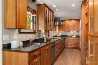 This amazing kitchen has so much to offer; 2 sinks, commercial gas range, cherry wood cabinets, pantry...