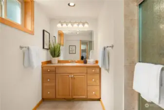The lower bathroom features tiled floors and a tiled shower as well as great storage in the vanity.