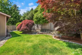 Beautifully landscaped with a nice sized grass yard and curving garden beds.