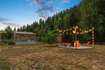 Backyard, green house, shed, and fire pit