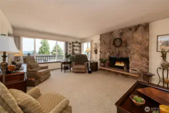 Spacious Living Room with wood burning fireplace and gorgeous Sound and Mountain Views!