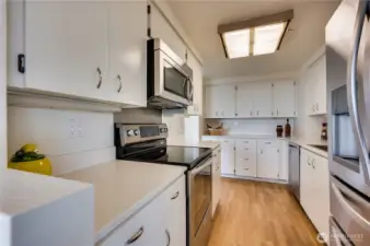 Lots of cabinet & counter space in your kitchen with oak hardwood floors & stainless steel appliances.