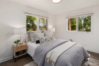The third bedroom is bright and inviting, with two windows bringing in plenty of natural light. Soft neutral tones and warm lighting create a comfortable retreat.