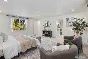 This bedroom is so spacious, with plush carpeting and soft, neutral tones creating a relaxing atmosphere. The ensuite bath is just steps away, offering convenience and privacy. Large windows on opposite walls offer a nice cross breeze in the summer.