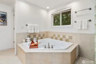 Unwind in the comfort of this comfy jetted tub, surrounded by soft lighting and elegant tilework—perfect for a relaxing soak at the end of the day.