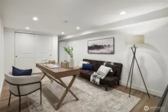 This adaptable basement room features a spacious closet with sliding doors, offering ample storage. Its quiet location makes it ideal for a home office or cozy den, or hobby room, providing flexibility to suit your needs.