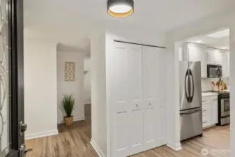 The spacious foyer offers a warm welcome while maintaining privacy for the living areas. A large coat closet keeps essentials organized, and the open layout provides an easy flow to the kitchen and living room for effortless entertaining.