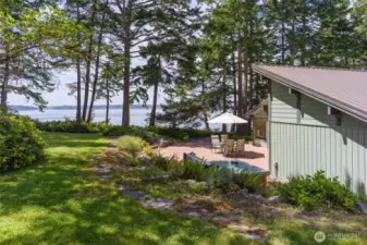 Westside, all cedar beach house tucked at the end of a quiet road offers 295 ft of waterfront & views over San Juan Channel, the Straits & Olympic Mtns.