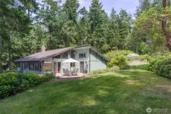 South side of the home with greenhouse to far right.
