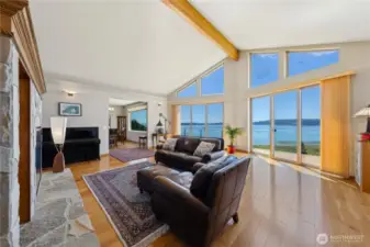 This view spans from one end of the home to the other!  Look to the left and you will see the dining room and a huge water view window.