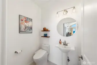 Bright, light clean Guest Bath on the main level. You can see the view reflected in the mirror.