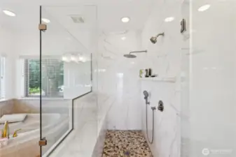 Isn't this a nice large, well designed tiled shower?  There is a built-in bench and a Rain shower head.