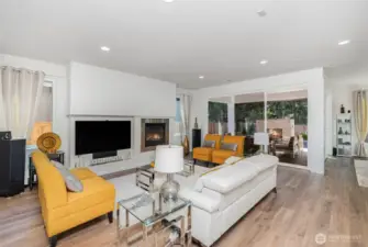 Another view of the living room highlights the oversized sliding doors, bringing in abundant natural light and offering seamless access to the outdoor space.