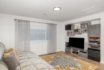 Spacious upstairs bonus room with large window and charming cut out for storage needs.