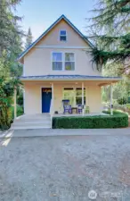 Two story home with covered front deck entrance.