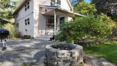 Back door patio area with fire pit. The garden is to the left, the right, everywhere there is something.