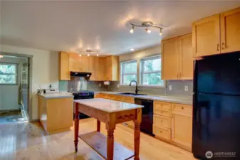 Kitchen has plenty of counter and cupboard space. Bar height island conveys.