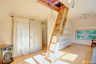 Second bedroom with closet space and shelving.  Fold down stairs lead to the huge attic.