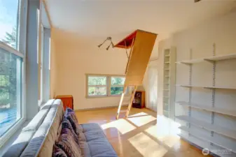 Stairs are easy to tuck away into the ceiling. Look at the natural light spilling into the space.