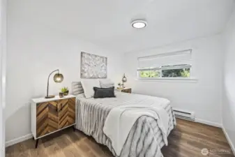 Bright primary bedroom filled with natural light.