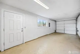 Garage fits two cars with sleek epoxy flooring.