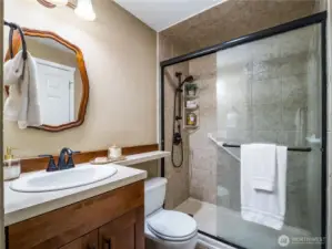 The upstairs bathroom has a full sized walk in shower