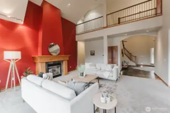 Vaulted ceilings and an elegant fireplace elevate the living room