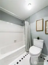 Enclosed toilet and shower/tub