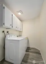 Full laundry room with storage