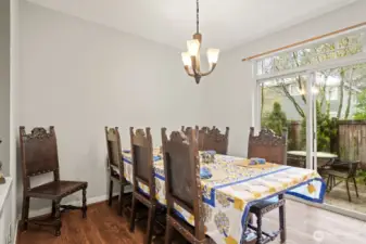 The spacious dining area features a sliding door to the backyard patio and the guest powder bath is updated with a vessel sink and tile floor.