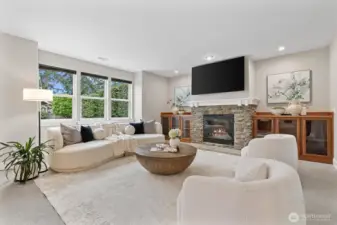Spacious great room with gas fireplace, custom built-ins, and open-concept connection to the kitchen, designed for comfortable living and entertaining.