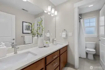 Updated upstairs bathroom featuring quartz countertops, modern cabinetry, and refreshed finishes for a clean, contemporary feel.