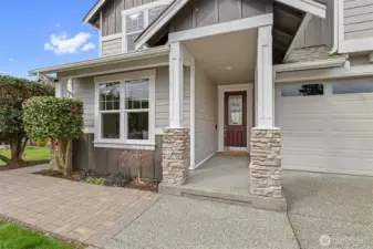 Covered front entry with tall door and welcoming porch, offering a warm first impression and sheltered access in this quiet Wyndham Grove cul-de-sac setting.
