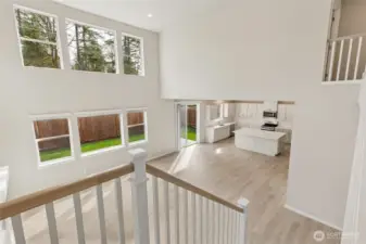 Dramatic view from midway up the stairs showing all the natural light. Photos are representative only and may display different color package and/or upgrades.