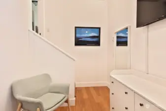 Looking back at the steps that lead to the hallway. There is a pocket door for this bedroom and an electric wall heater as its heat source.
