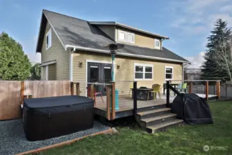 Current owners expanded the deck and added the hot tub. Fenced area beyond the hot tub is the perfect place to store your kayaks. Dormers on the second level provide extra light and a sense of spaciousness.  French doors lead to your open dining/living room.