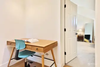 Let's check out the Primary Suite first. Bamboo floors continue up the stairs and onto this flex space. Both upper level bedrooms have wall to wall carpet.