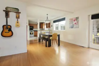 The propane fireplace is to your back and you can now see into the kitchen & dining area. There is a closet located along the wall to the left of the dining room table. A great coat closet!