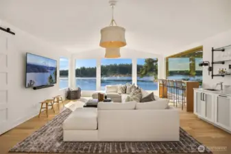 Living room with breathtaking views and built in wet bar w/ bev fridge and icemaker. Top quality designer sourced furnishings.