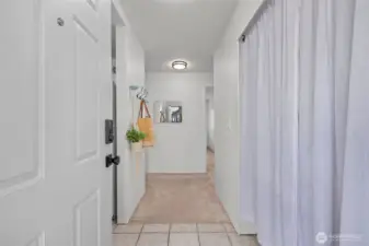 The closet to the right was re-imagined as a pantry and mud-room style. Enjoy custom shelving and a newer microwave!