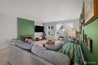 Cozy living room with wood-burning fireplace, accent walls, and SO MUCH SPACE! This couch is huge