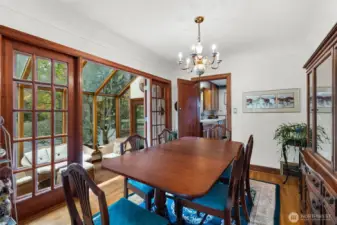 A private dining room, complemented by an adjoining sunroom, creates an intimate and inviting dining experience.