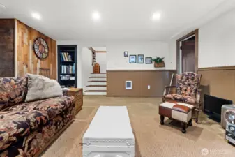 Carpeted for comfort and insulation, the front portion of the basement provides a versatile living space.
